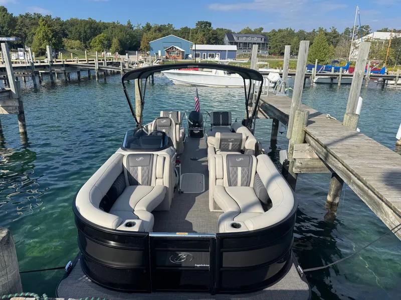 Slide: The Image of A sleek pontoon boat with luxurious seating, docked at a wooden pier in a tranquil harbor. - 1
