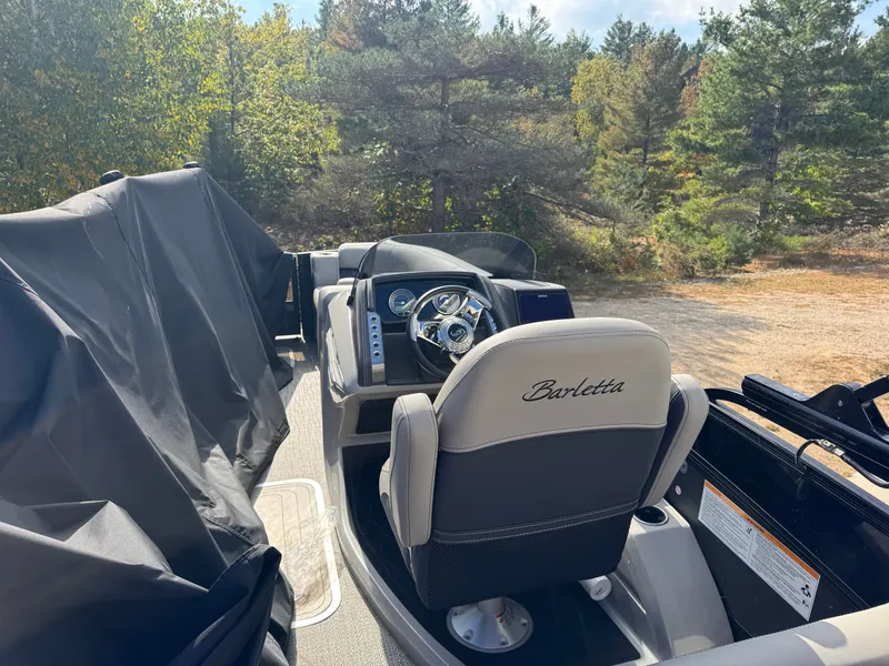 Slide: The Image of The image shows the cockpit of a 2024 Barletta Lusso 23M, surrounded by trees. - 5