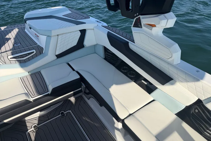 Slide: The Image of Interior seating of 2023 Nautique Super Air Nautique G23 boat on water. - 14