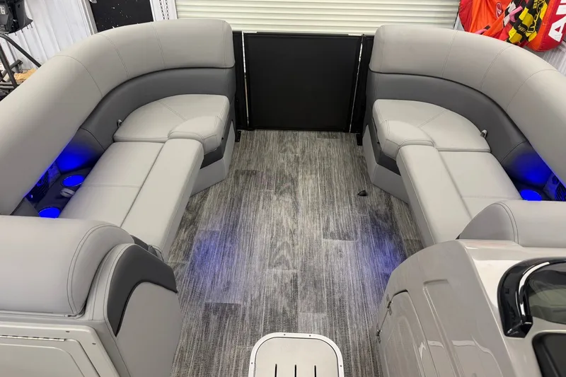 Slide: The Image of 2026 Bentley Pontoons Elite 223 Swingback interior with gray seating and blue LED lighting. - 15