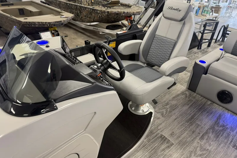Slide: The Image of 2026 Bentley Pontoons Elite 223 Swingback interior with luxurious captain's chair and modern dashboard. - 9