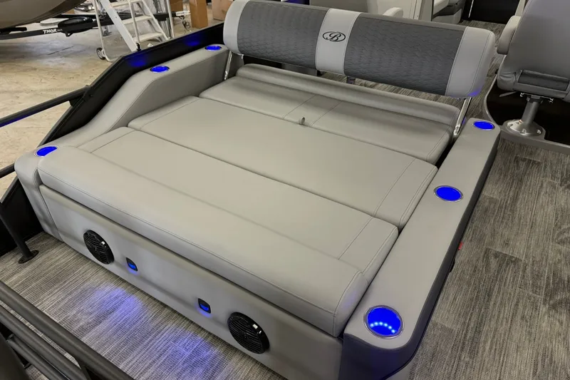 Slide: The Image of 2026 Bentley Pontoons Elite 223 Swingback with luxurious seating and ambient blue lighting. - 14