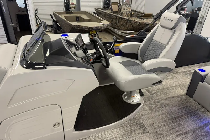 Slide: The Image of 2026 Bentley Pontoons Elite 223 Swingback interior with luxurious captain's chair and modern dashboard. - 5
