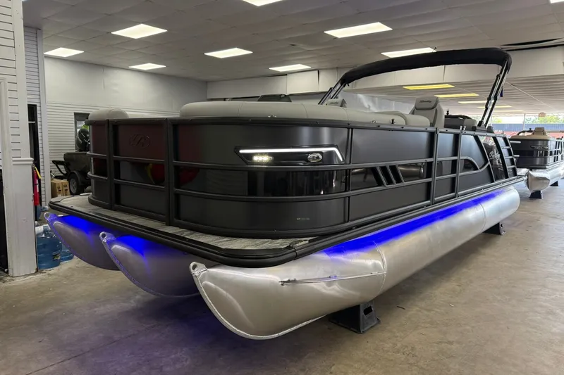 The Image of 2026 Bentley Pontoons Elite 223 Swingback with sleek design and blue underglow lighting. - 0