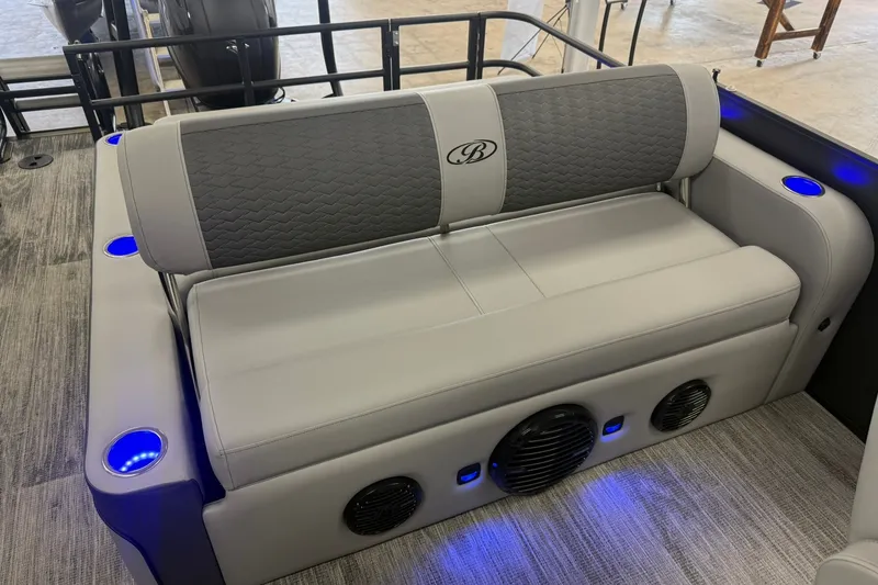 Slide: The Image of 2026 Bentley Pontoons Elite 223 Swingback interior with gray seating and blue LED cup holders. - 11