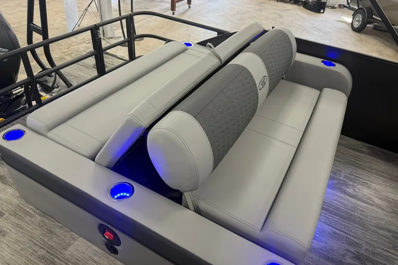 Slide: The Image of 2026 Bentley Pontoons Elite 223 Swingback with luxurious seating and blue LED cup holders. - 12
