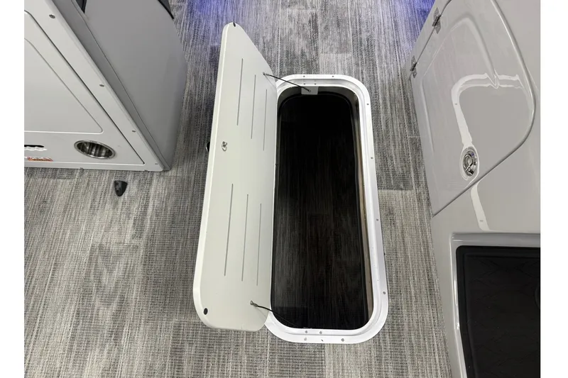 Slide: The Image of Open storage compartment on 2026 Bentley Pontoons Elite 223 Swingback boat. - 17