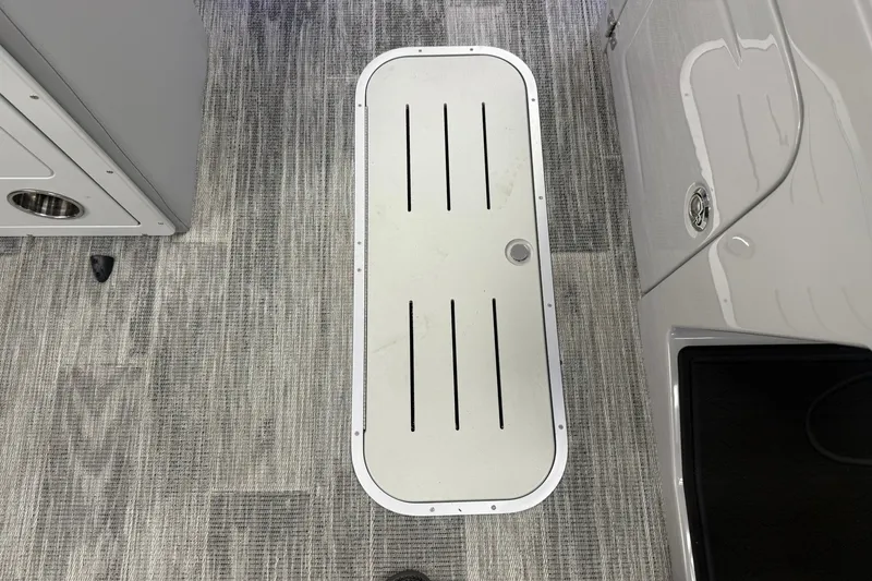 Slide: The Image of Interior view of 2026 Bentley Pontoons Elite 223 Swingback, featuring sleek flooring and storage compartment. - 16