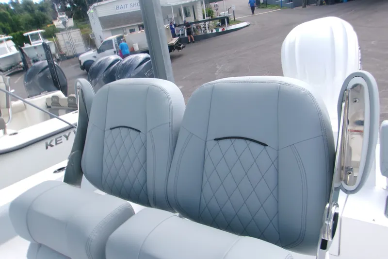 Slide: The Image of 2027 Sportsman Heritage 231 Center Console boat seats with diamond stitching detail. - 4