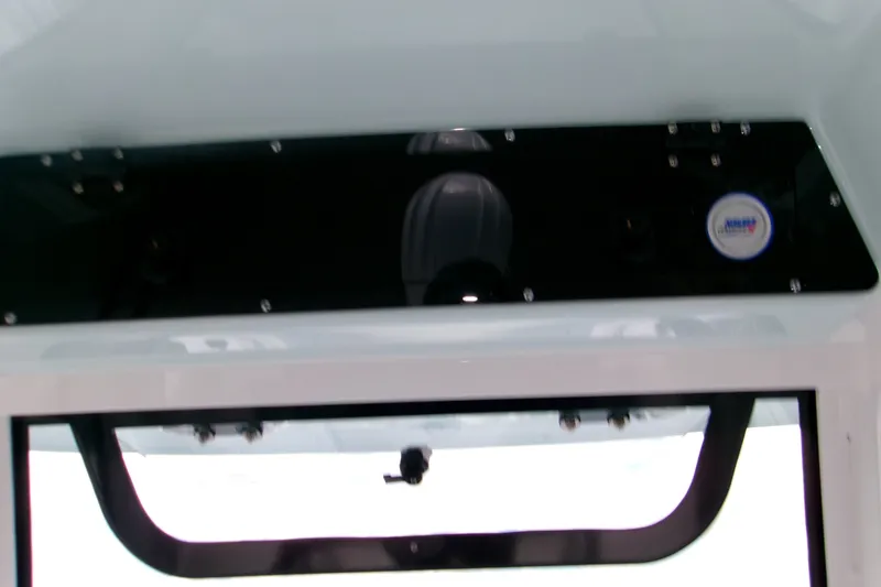 Slide: The Image of 2027 Sportsman Heritage 231 Center Console dashboard view with black panel and logo. - 8