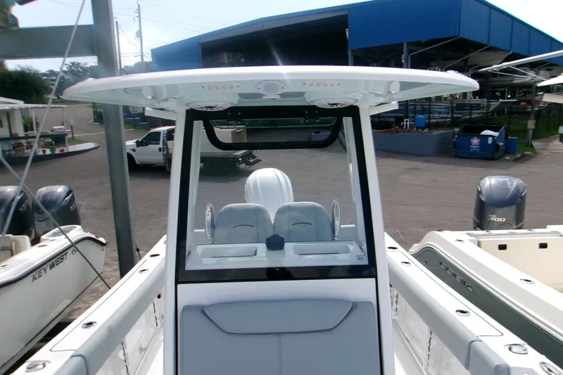 Slide: The Image of 2027 Sportsman Heritage 231 Center Console boat at marina, showcasing helm and seating area. - 11