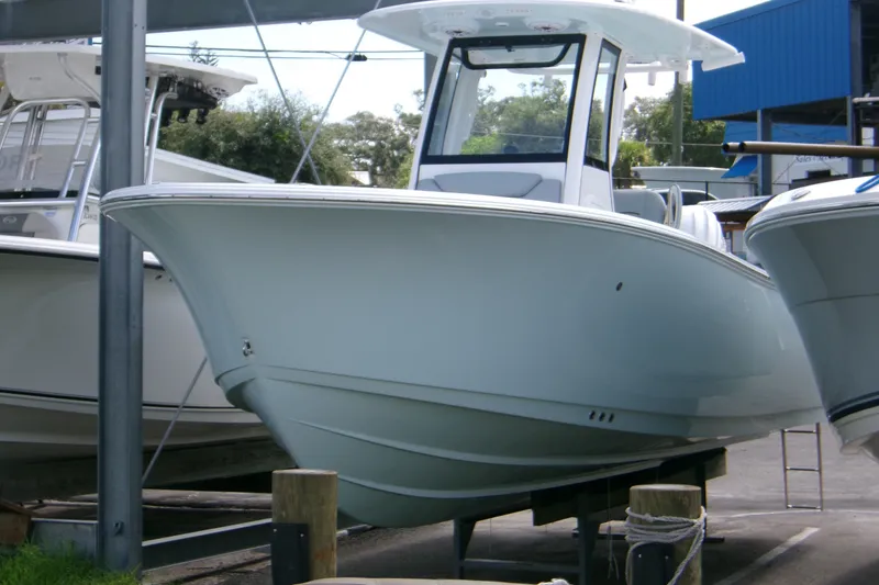 The Image of 2027 Sportsman Heritage 231 Center Console boat displayed in a marina setting. - 1