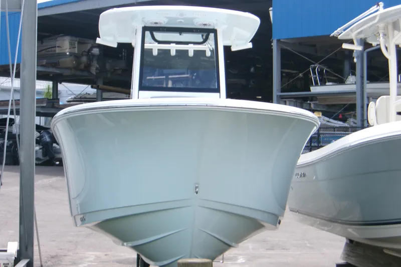 Slide: The Image of 2027 Sportsman Heritage 231 Center Console boat in a marina setting. - 16