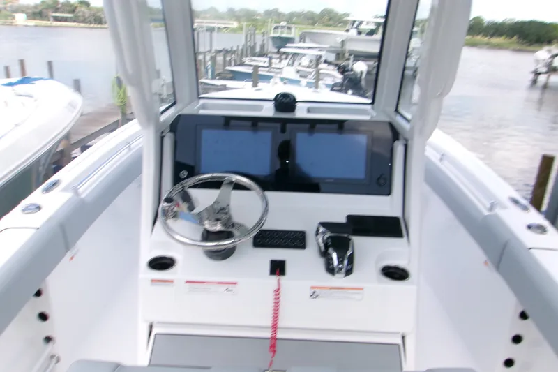 Slide: The Image of 2027 Sportsman Heritage 231 Center Console boat interior with steering wheel and control panel. - 3