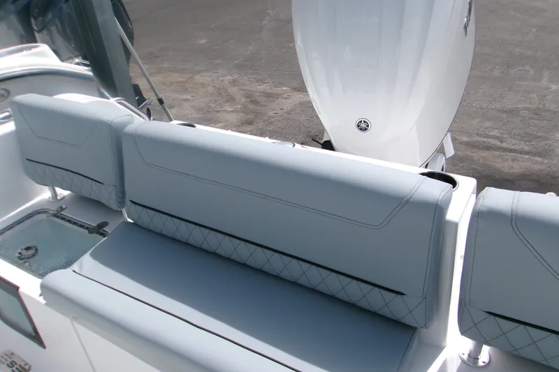 Slide: The Image of 2027 Sportsman Heritage 231 Center Console boat with sleek seating and powerful outboard motor. - 13