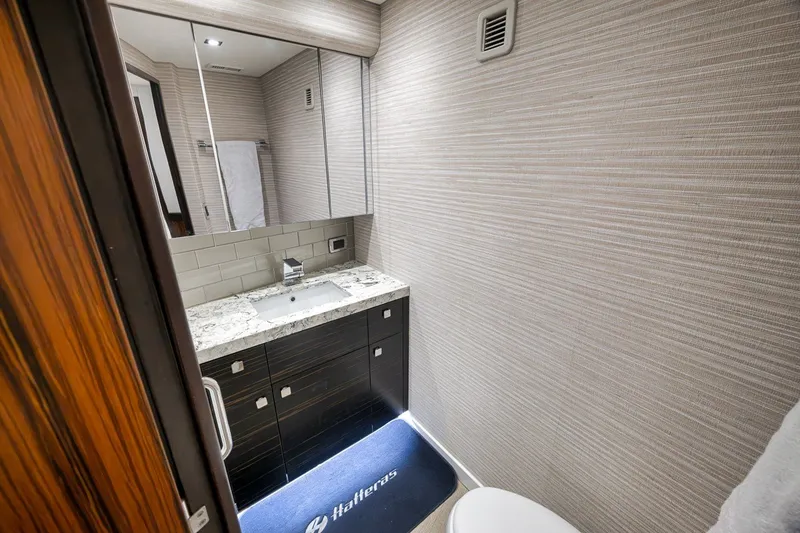 Slide: The Image of Luxurious bathroom in 2021 Hatteras GT65 Carolina yacht with modern fixtures and elegant design. - 45