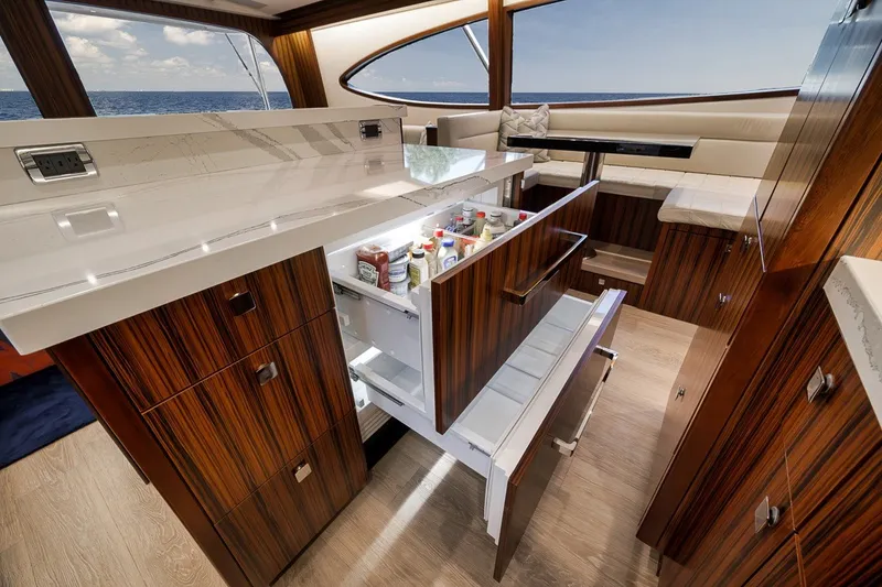 Slide: The Image of Luxurious 2021 Hatteras GT65 Carolina yacht interior with open drawers and ocean view. - 38