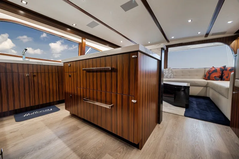 Slide: The Image of Luxurious interior of 2021 Hatteras GT65 Carolina yacht with elegant wood cabinetry and plush seating. - 37