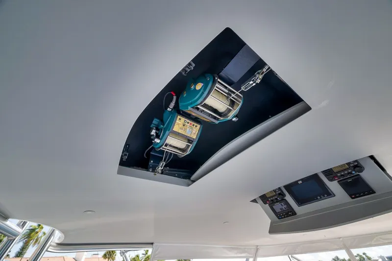 Slide: The Image of 2021 Hatteras GT65 Carolina yacht ceiling with fishing reel and control panels. - 20