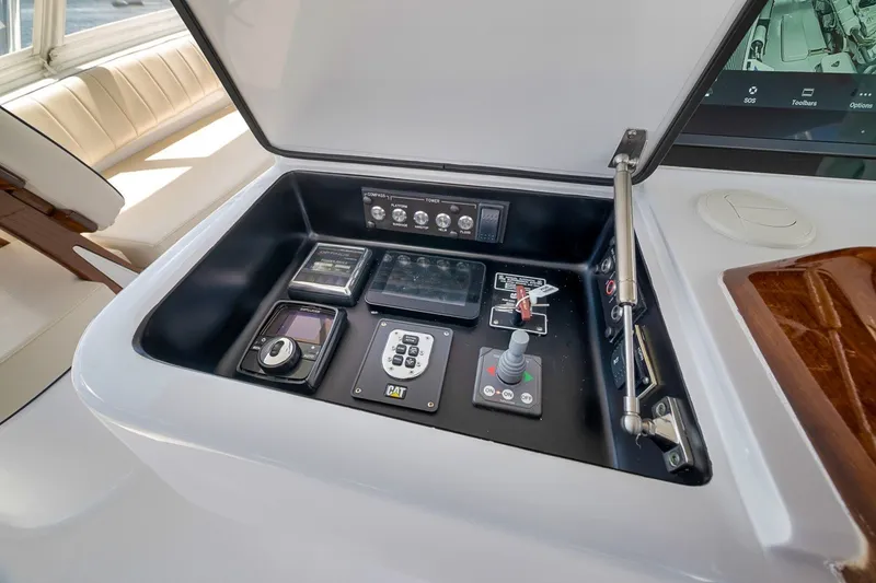 Slide: The Image of Control panel of 2021 Hatteras GT65 Carolina yacht with navigation and engine controls. - 18