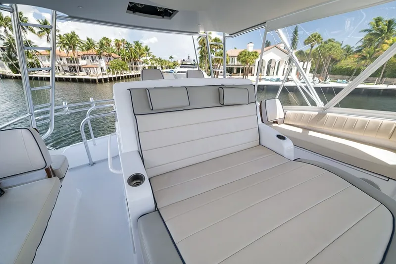 Slide: The Image of Luxurious seating on 2021 Hatteras GT65 Carolina yacht, docked near waterfront homes. - 26