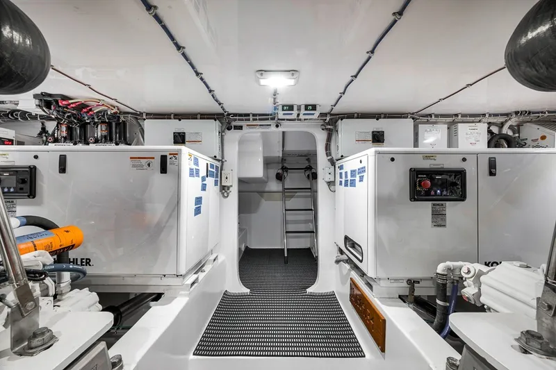Slide: The Image of Engine room of 2021 Hatteras GT65 Carolina yacht, featuring Kohler generators and advanced equipment. - 57