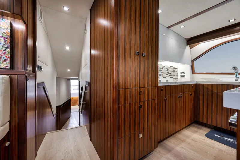 Slide: The Image of Luxurious interior of 2021 Hatteras GT65 Carolina yacht with sleek wood cabinetry. - 40