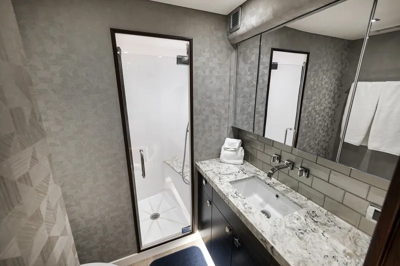 Slide: The Image of Luxurious bathroom in 2021 Hatteras GT65 Carolina yacht with modern fixtures and elegant design. - 43