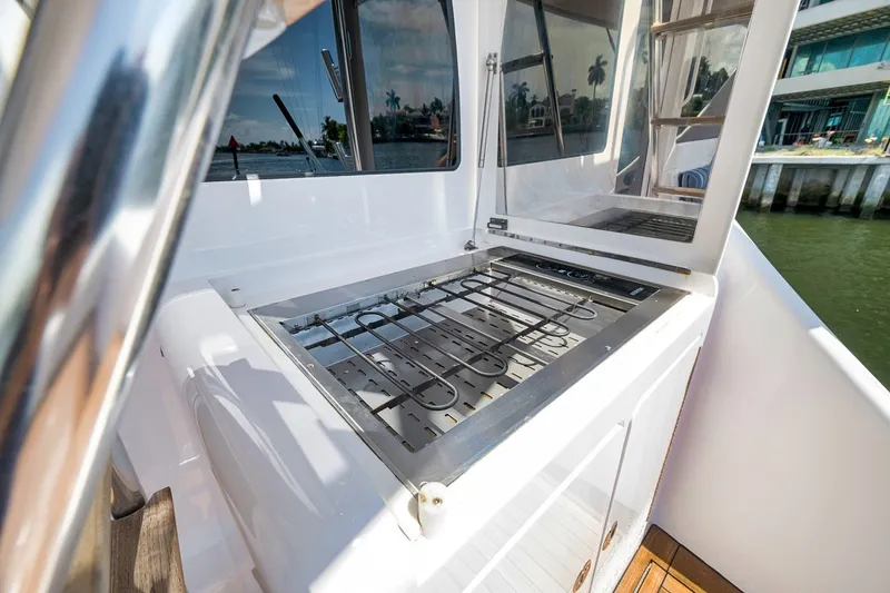 Slide: The Image of Outdoor grill on 2021 Hatteras GT65 Carolina yacht deck, near waterfront. - 15