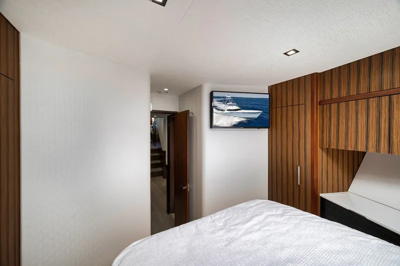 Slide: The Image of Luxurious interior of 2021 Hatteras GT65 Carolina yacht bedroom with wood paneling. - 49