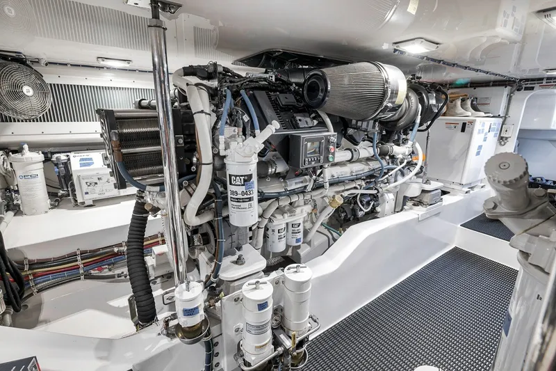 Slide: The Image of Engine room of 2021 Hatteras GT65 Carolina yacht, showcasing advanced machinery and components. - 53