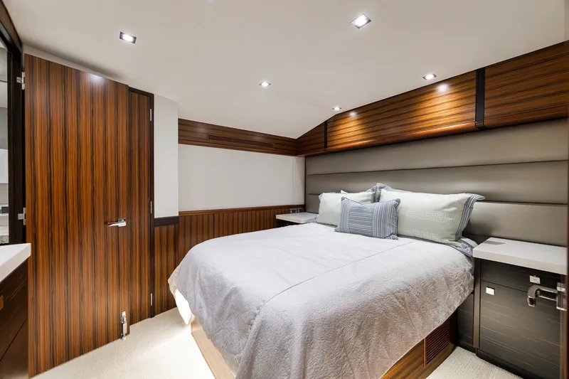 Slide: The Image of Luxurious bedroom interior of 2021 Hatteras GT65 Carolina yacht with modern wood finishes. - 41