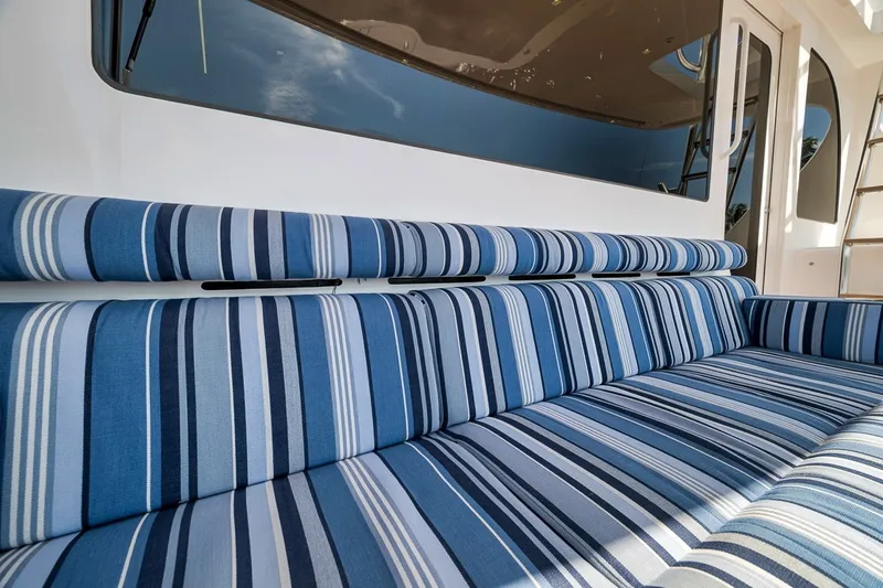 Slide: The Image of Striped blue seating on 2021 Hatteras GT65 Carolina yacht deck. - 13