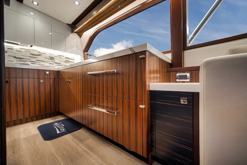 Slide: The Image of Luxurious interior of 2021 Hatteras GT65 Carolina yacht with sleek wood cabinetry. - 33