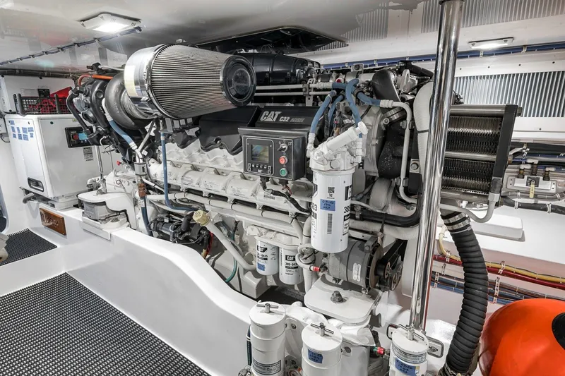 Slide: The Image of Engine room of 2021 Hatteras GT65 Carolina yacht, featuring advanced machinery and components. - 54
