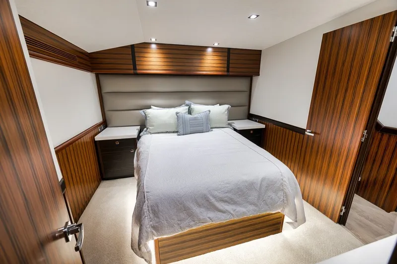 Slide: The Image of Luxurious bedroom interior of 2021 Hatteras GT65 Carolina yacht with wood paneling. - 42