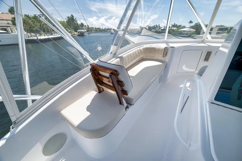 Slide: The Image of 2021 Hatteras GT65 Carolina yacht interior with seating, overlooking a scenic waterway. - 23