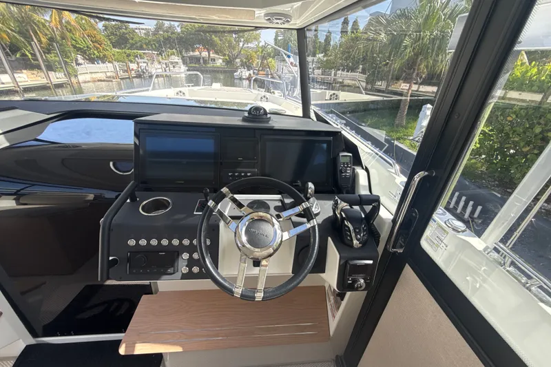 Slide: The Image of 2024 Quarken 35 Cabin Tourer helm with modern controls and navigation screens. - 16
