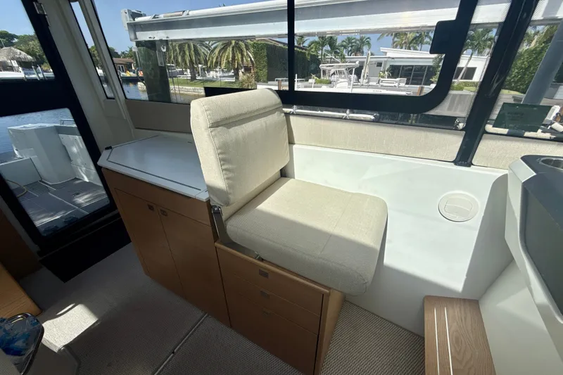 Slide: The Image of 2024 Quarken 35 Cabin Tourer interior with cushioned seating and scenic window view. - 18