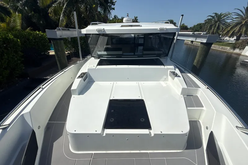 Slide: The Image of 2024 Quarken 35 Cabin Tourer boat docked, showcasing sleek design and spacious deck. - 27