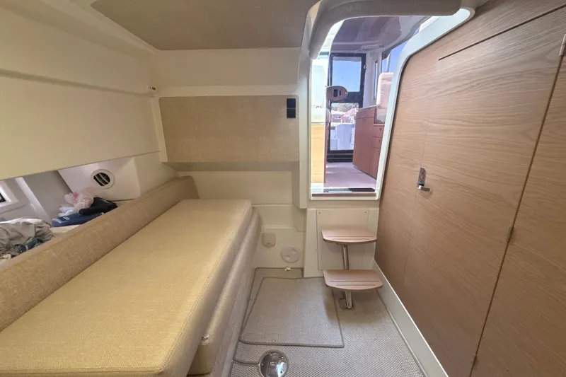 Slide: The Image of 2024 Quarken 35 Cabin Tourer interior with beige seating and wooden accents. - 22