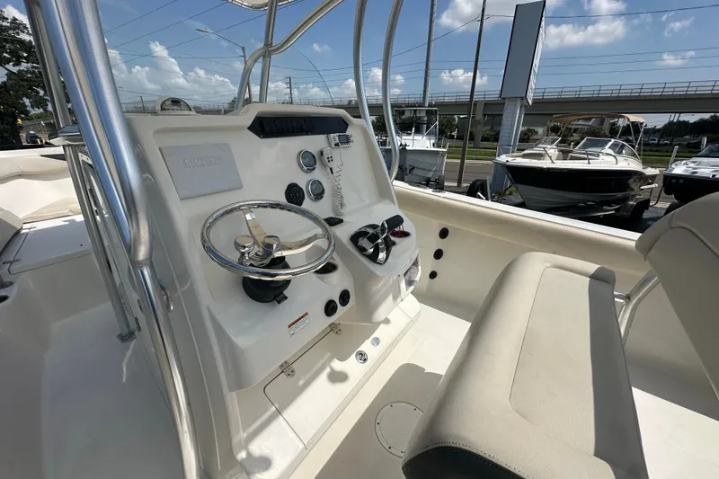 Slide: The Image of 2023 Sailfish 242 CC boat cockpit with steering wheel and control panel. - 12