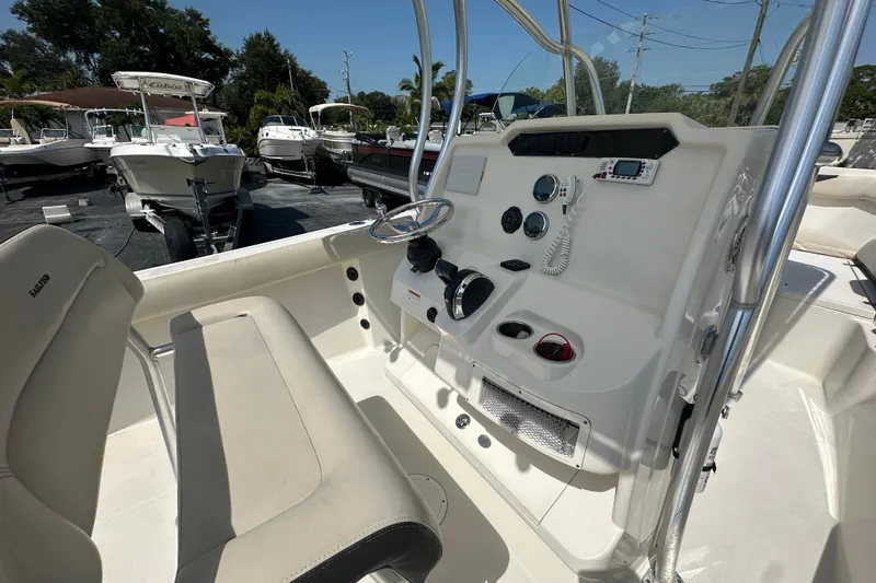 Slide: The Image of 2023 Sailfish 242 CC boat console with steering wheel and controls. - 13