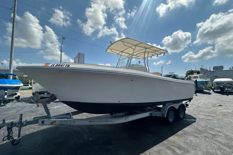 The Image of 2023 Sailfish 242 CC boat on trailer under sunny sky. - 0