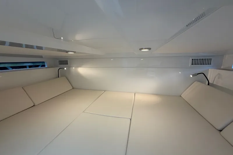 Slide: The Image of Interior cabin of 2027 De Antonio Yachts D32, featuring sleek white design and modern lighting. - 15