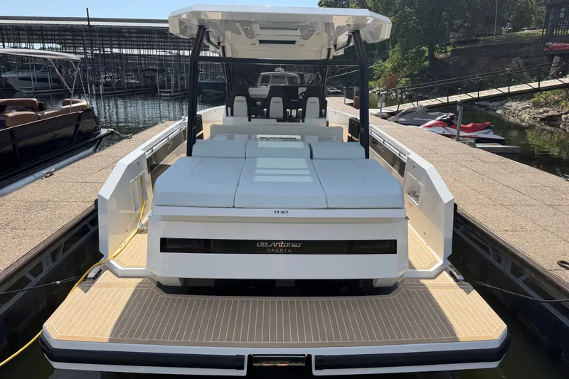 Slide: The Image of 2027 De Antonio Yachts D32 docked, showcasing sleek design and spacious deck. - 4