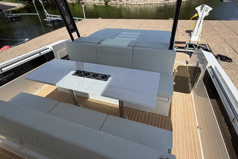 Slide: The Image of Luxury seating area on 2027 De Antonio Yachts D32 with elegant table and cup holders. - 9