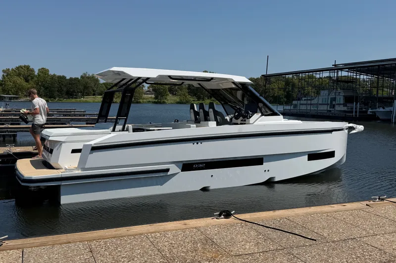 Slide: The Image of 2027 De Antonio Yachts D32 docked, sleek white design, modern features, sunny day. - 3