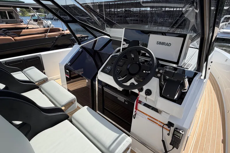 Slide: The Image of 2027 De Antonio Yachts D32 helm with Simrad navigation system and luxurious seating. - 13