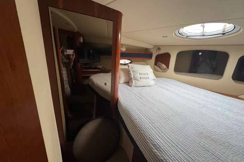 Slide: The Image of Interior cabin of 2006 Cruisers Yachts 370 Express with bed and porthole window. - 31